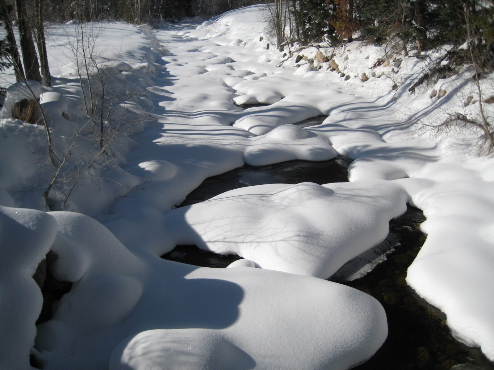 water flowing under snow