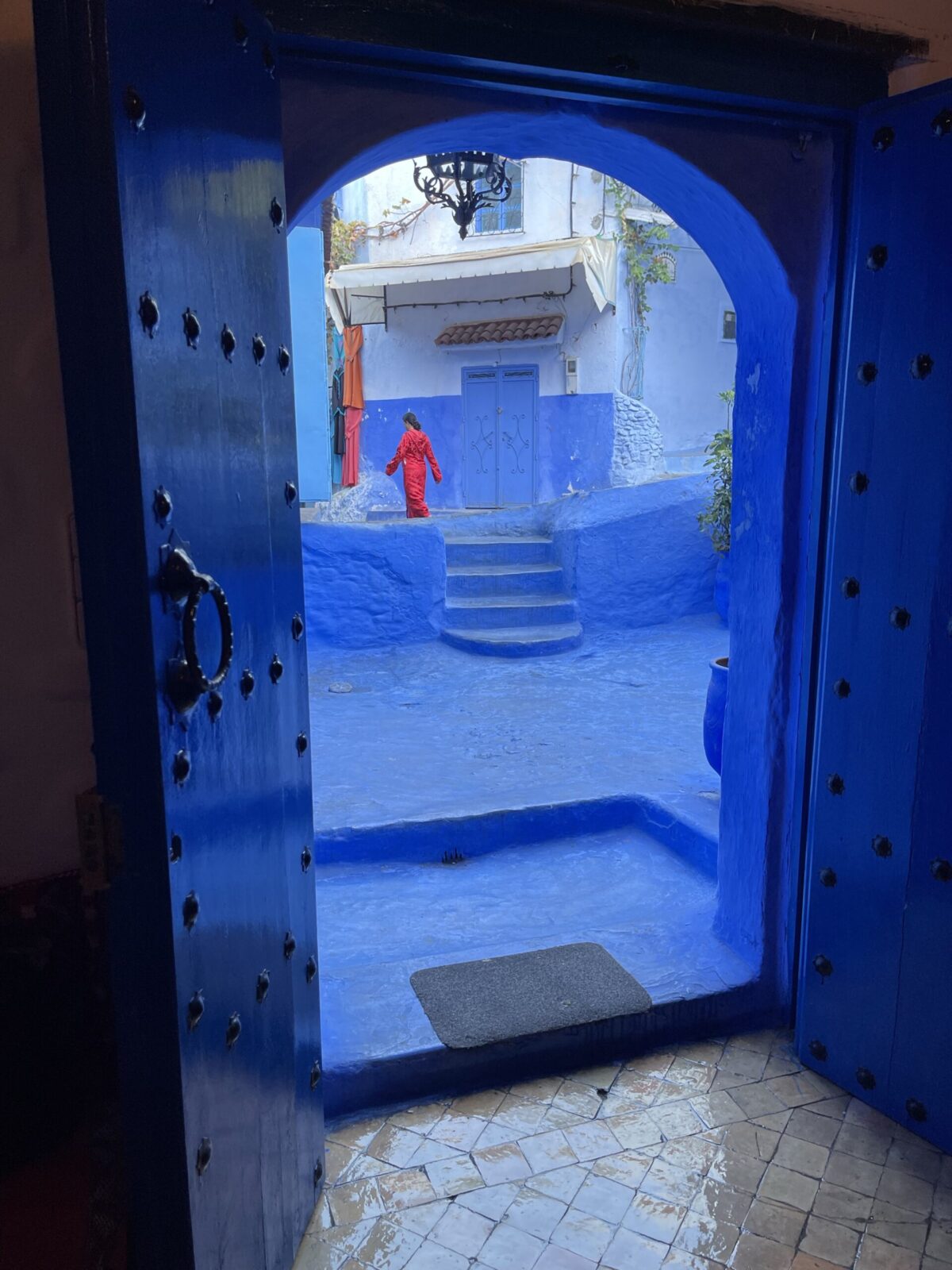 blue buildings with person in a red dress