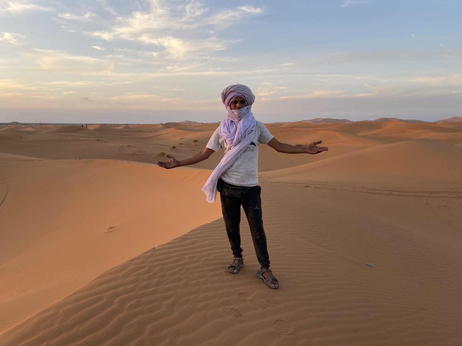 man standing in the sand dunes